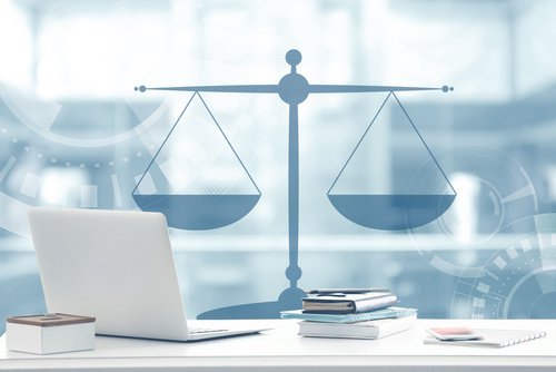 Law concept. Lawyer workplace with laptop and scales of justice